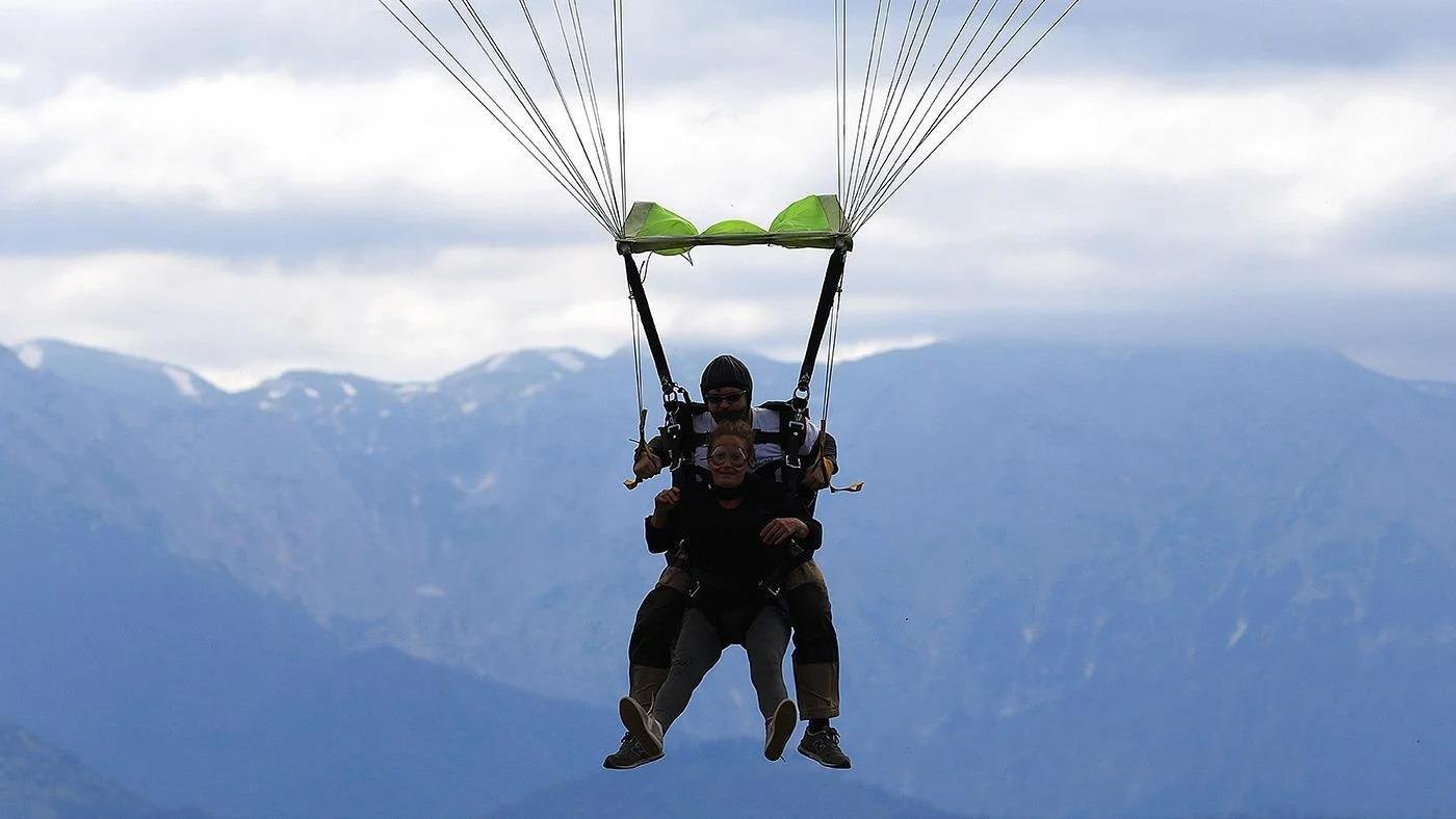 Skydiver descending with open parachute during a skydiving over Palm Jumeirah experience