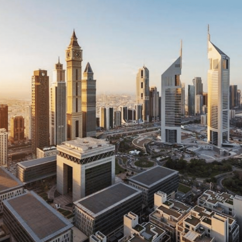 Dubai skyline featuring iconic skyscrapers against a clear blue sky.