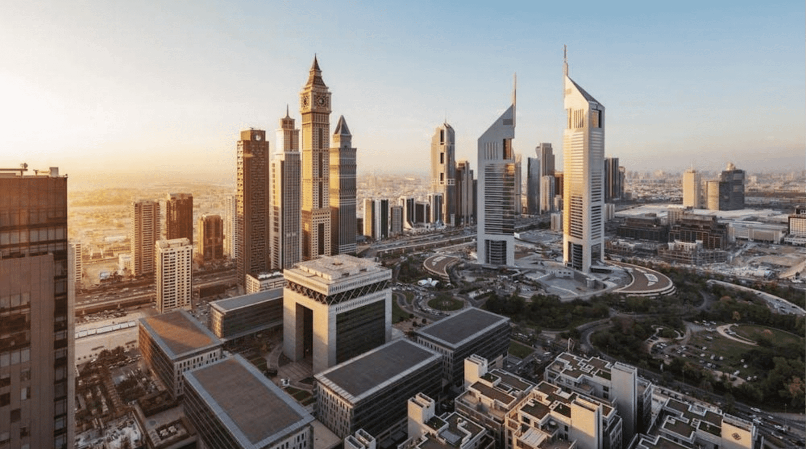 Dubai skyline featuring iconic skyscrapers against a clear blue sky.